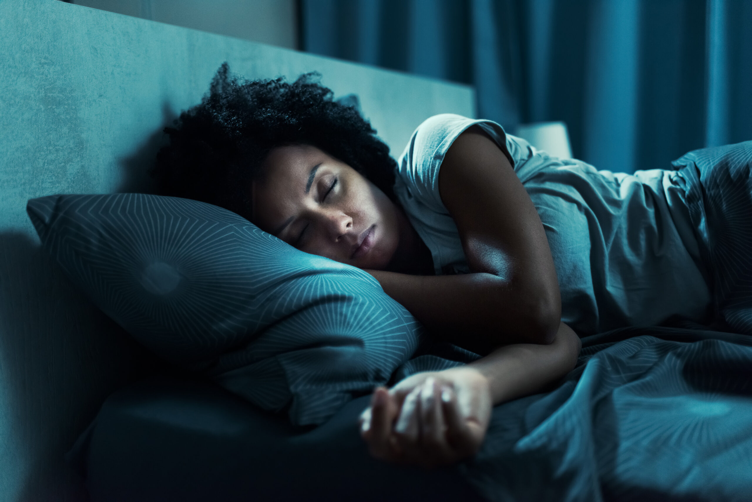A woman sleeping in her bed